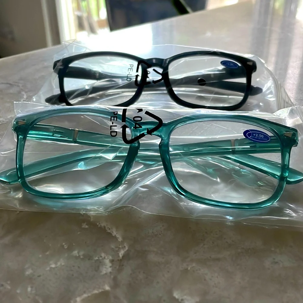 Two pairs readers 2.5 + blue light combination readers one black and one teal